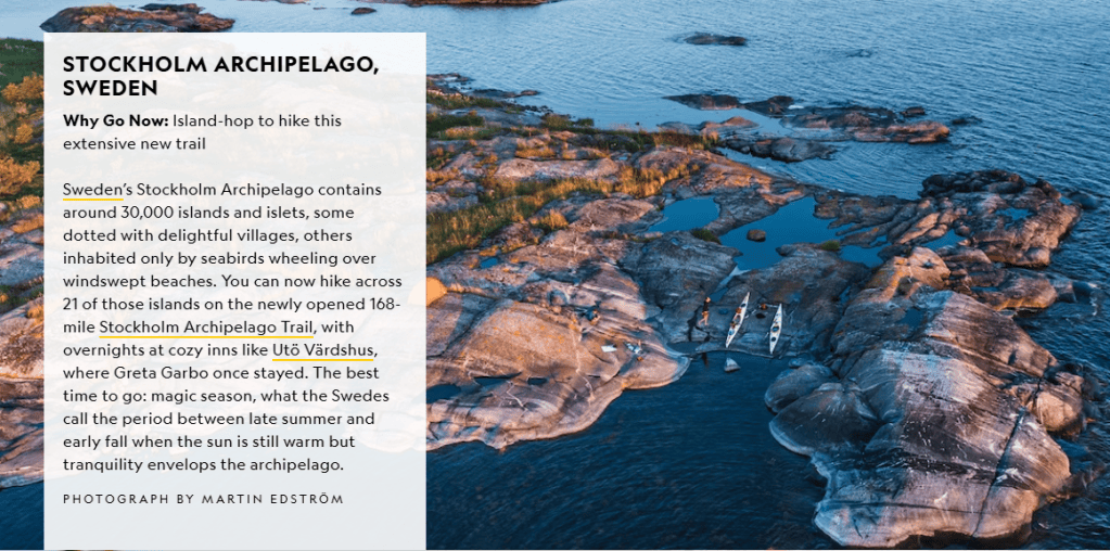 Aerial view of the Stockholm Archipelago in Sweden, showcasing rocky islands and calm waters with two kayakers paddling.
